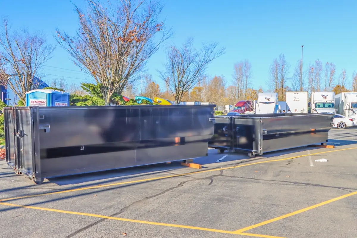 Professional dumpster rental service with roll-off container on residential driveway in Kittery